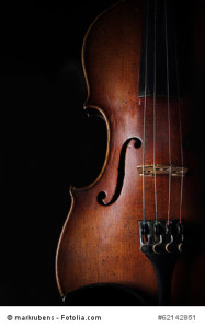Part of very old scratched violin on dark background. Closeup view.